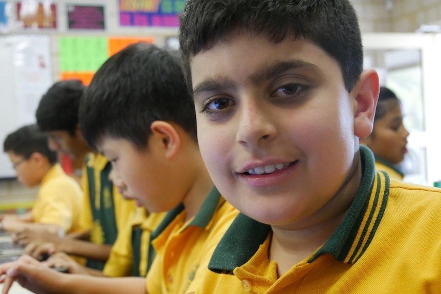 Children working on computers in a classroom