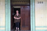 Liz Berger stands in a doorway of a pub.