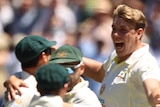 Australian Test cricketers run to celebrate with a jumping Cameron Green after winning the third Ashes Test at the MCG.