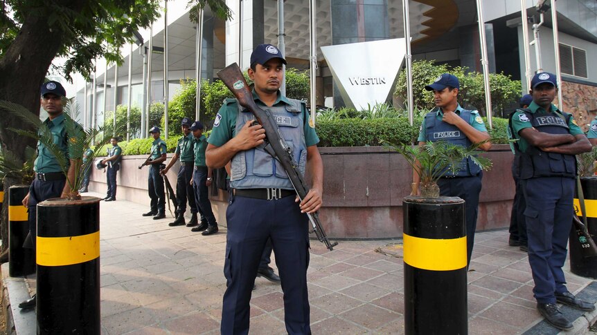 Police stand guard outside the Westin Hotel in Dhaka where Australia's national football team is staying