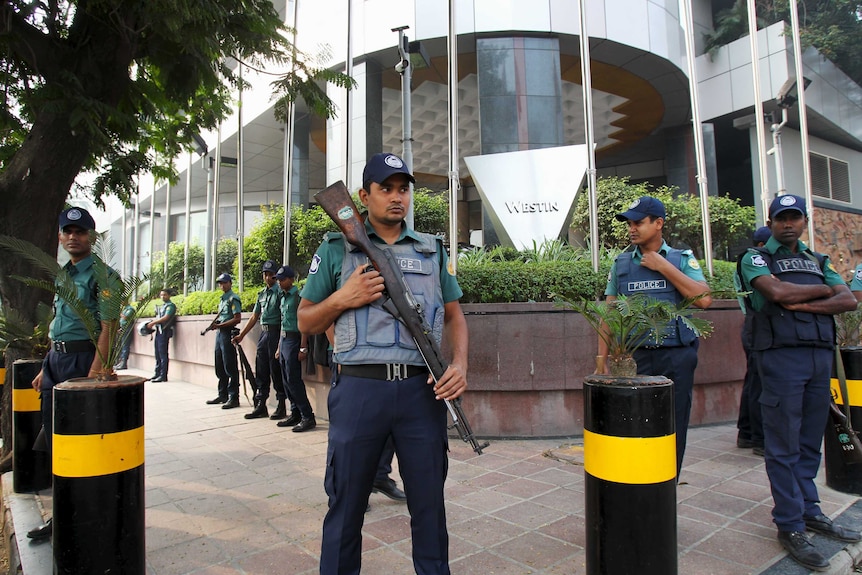 Police stand guard outside the Westin Hotel in Dhaka where Australia's national football team is staying