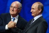 Sepp Blatter shakes hands with Vladimir Putin in Russia on Saturday, July 25