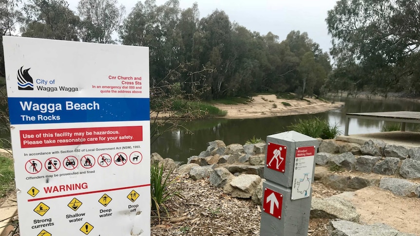 A City of Wagga Wagga Council warning sign at rocks by the Murrumbidgee River