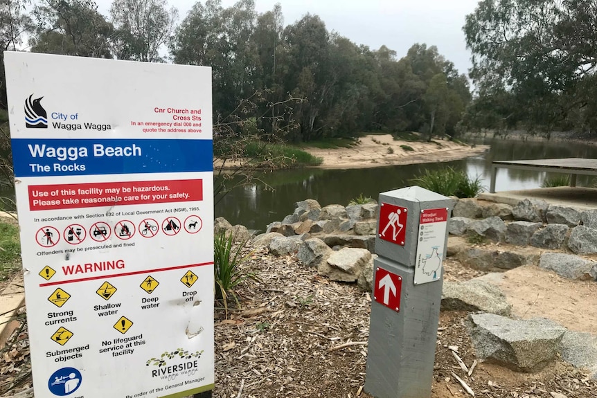 A City of Wagga Wagga Council warning sign at rocks by the Murrumbidgee River