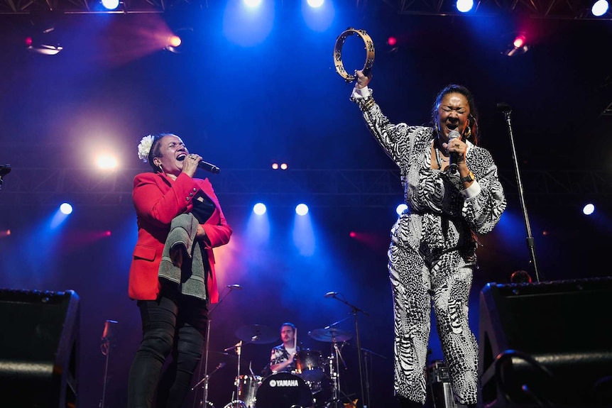 Vika and Linda Bull singing with their eyes closed on stage at Bluesfest