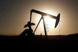 An oil well pump jack is seen at sunrise near Bakersfield, California