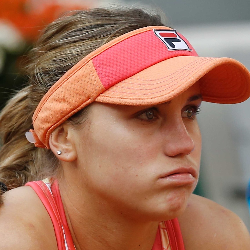 A dejected tennis player looks out at the court after losing the French Open women's singles final.