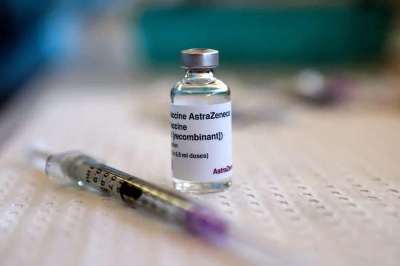 A small vaccine bottle sits on a table 