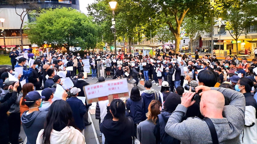 A crowd of people gather for a protest at the steps of the State Library in Melbourne. 