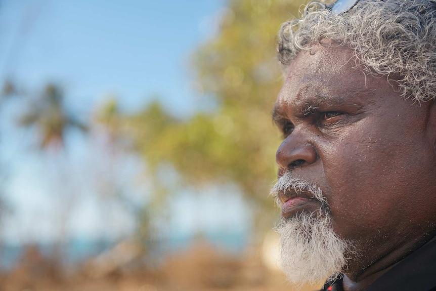 A close-up shot of Yingiya Guyula with the sea in the background.