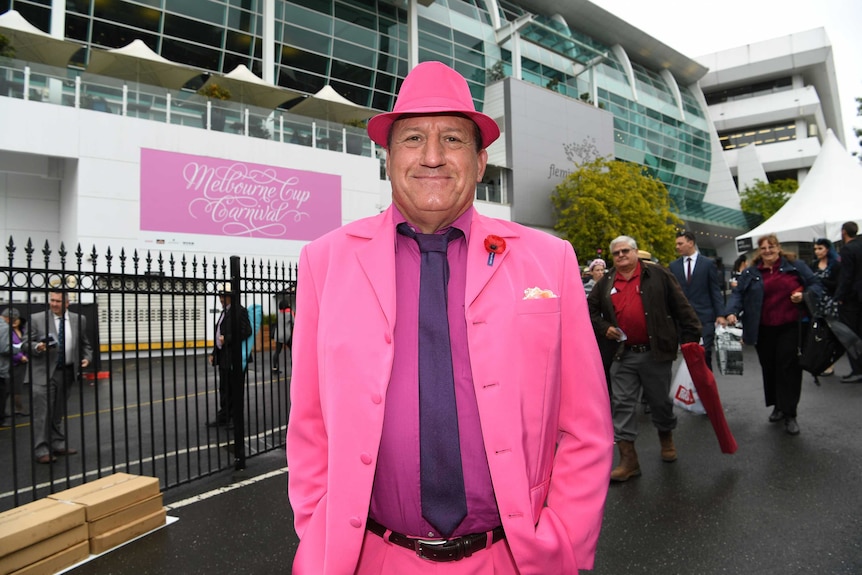 A man in a pink suit at the 2017 Melbourne Cup.