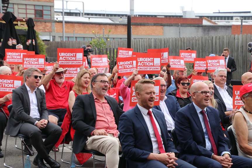 Some of the crowd at Labor's campaign launch, many are wearing red and holding red signs calling for cost of living action