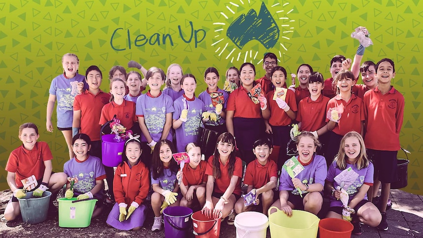 A class of students with gloves on and holding tongs and buckets with items of rubbish in them.