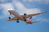 A QANTAS plane flying in the sky.