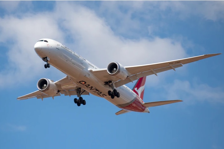 A QANTAS plane flying in the sky.