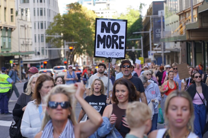 People protesting Sydney's CBD against the lack of action against domestic violence and violence against women