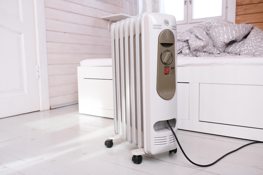 An electric slat heater in a bedroom.
