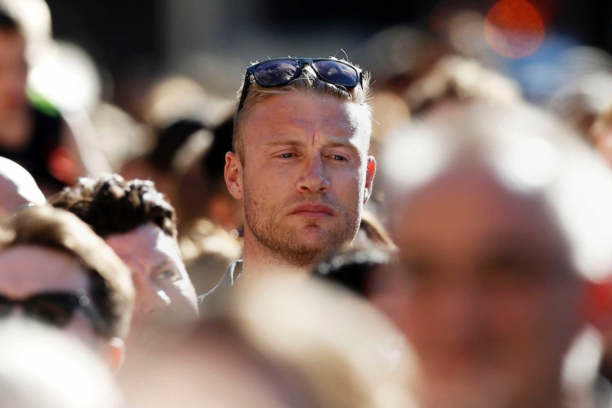 Andrew Flintoff stands at the Manchester vigil.