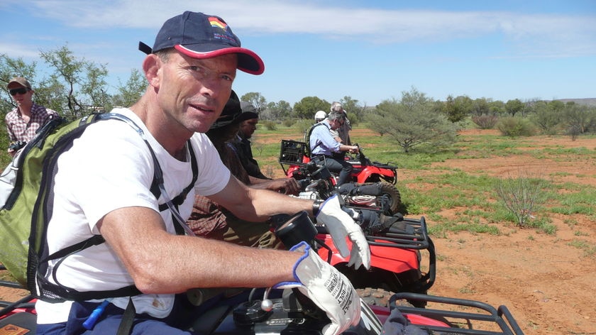 Tony Abbott on a quad bike