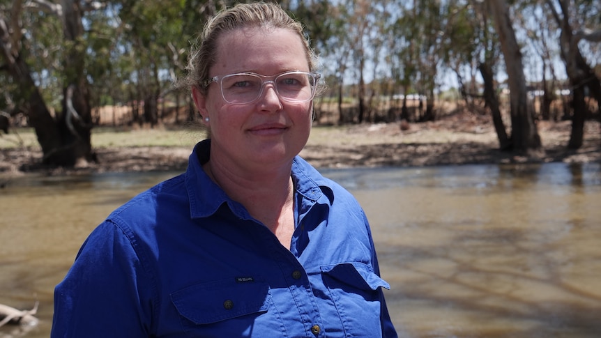 A close up shot of a woman in front of a river