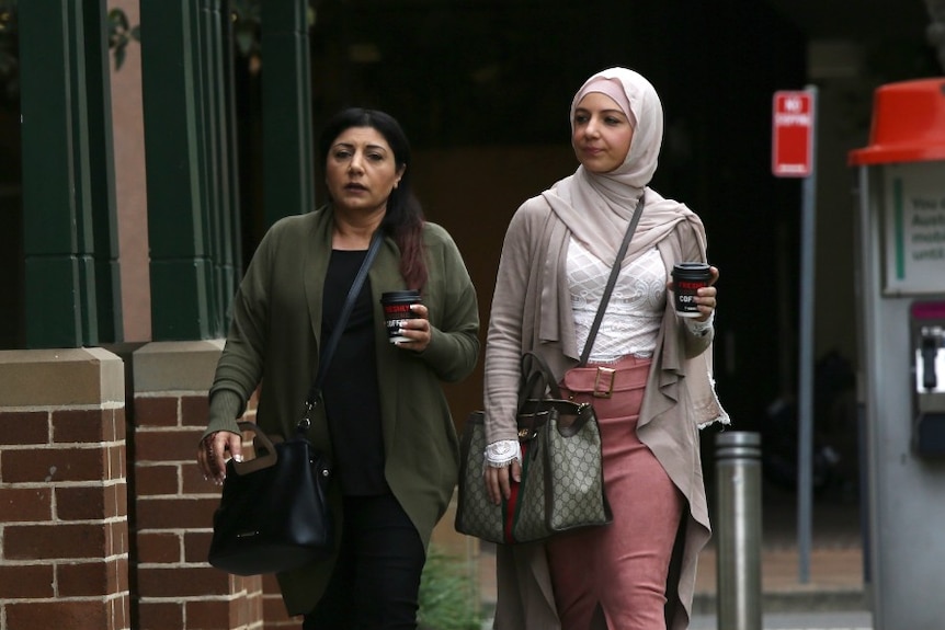 Two women walking side by side.