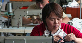 Chinese workers sew clothes at a garments factory.
