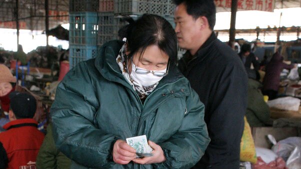 A woman wears a face mask to protect herself against SARS