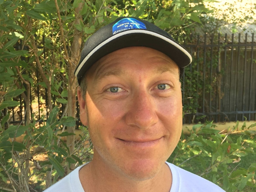 A close-up photo of storm chaser James Taylor wearing a blue baseball cap