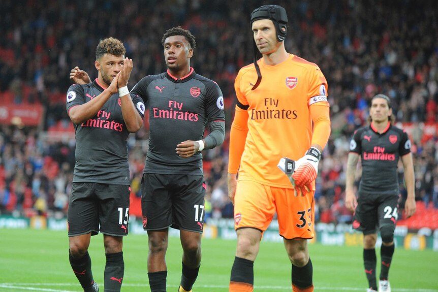 Arsenal's Alex Oxlade-Chamberlain, Alex Iwobi and Petr Cech walk off after Stoke City loss