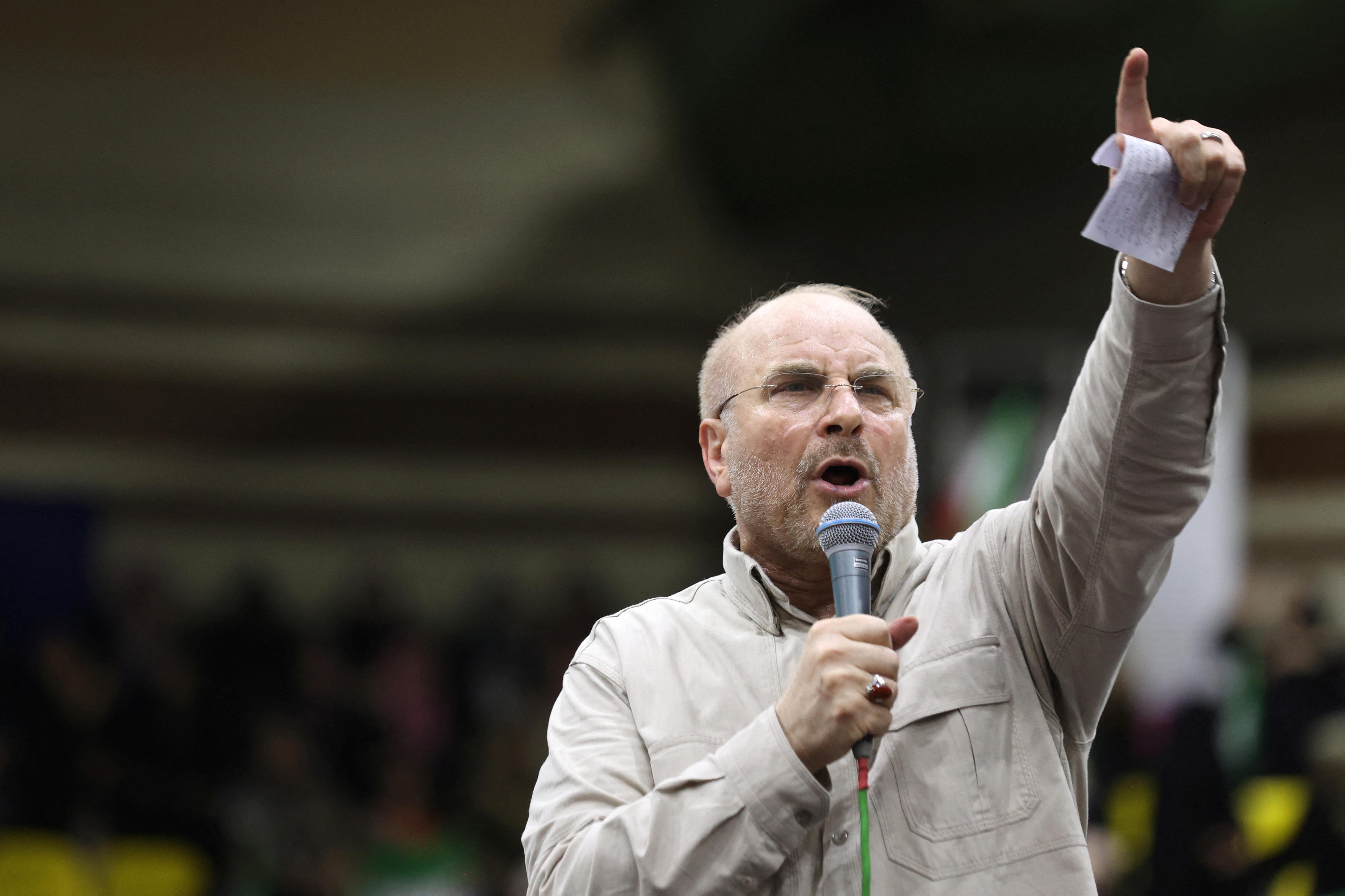 Mohammad Bagher Qalibaf speaks into a microphone at an event.