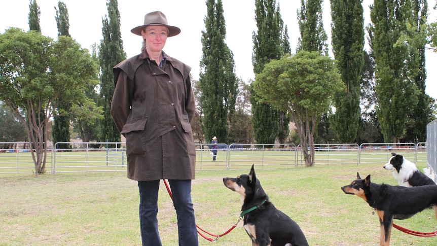 City woman in Drizabone and Akubra with Kelpie