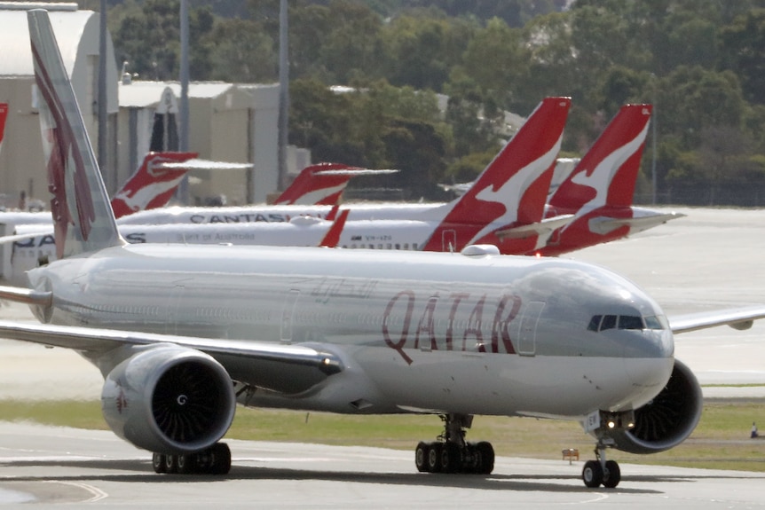 Qatar Airways and Qantas planes on tarmac in Perth.