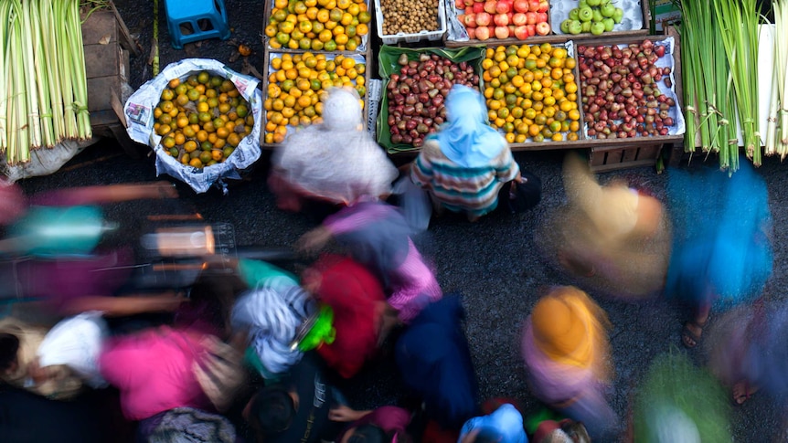 Blurred motion of people at a marketplace