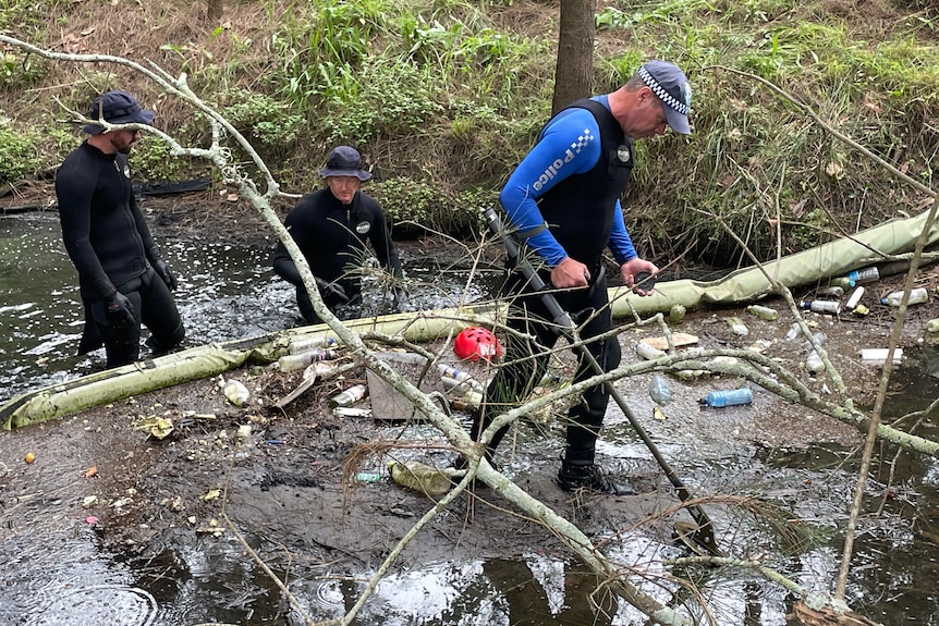 Men walking in a creek bed