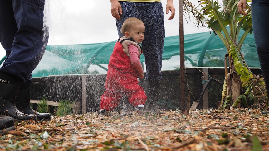 Cute baby dancing on the compost heap