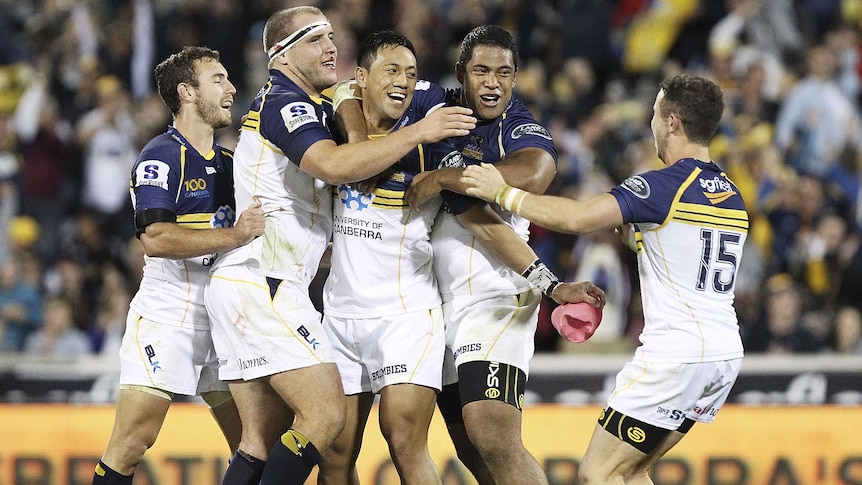 Clutch kick ... Christian Lealiifano (centre) is congratulated after his winning penalty goal.