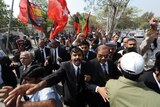 Pakistani lawyers and activists shout slogans as they march during a protest in Karachi.