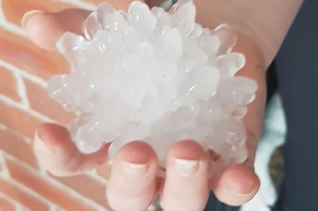 Huge hail stone in a hand after a storm at Rosewood, west of Brisbane, on October 31, 2020.