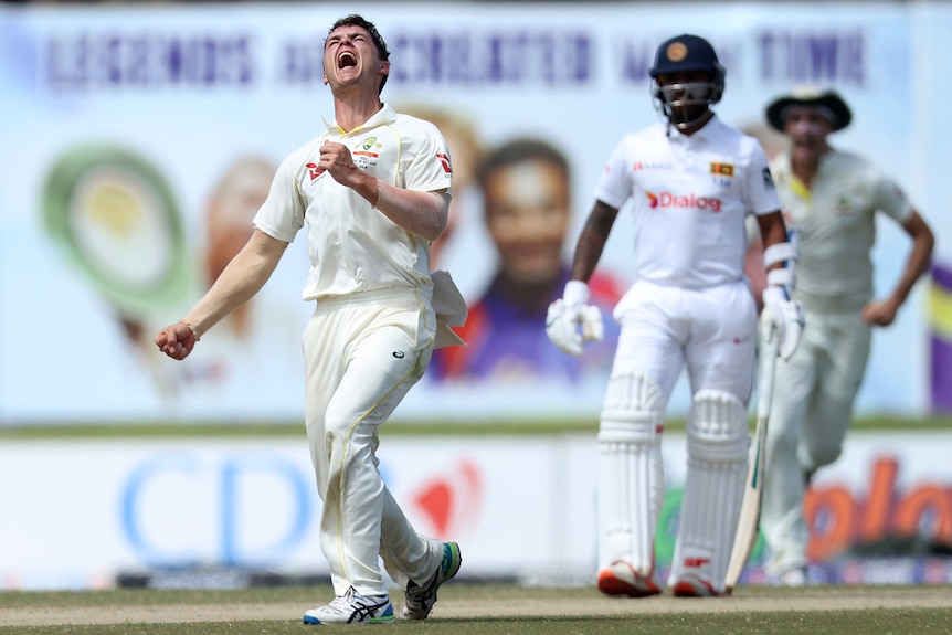 Mitch Swepson clenches his fist and yells in delight as a Sri Lankan batter looks disappointed
