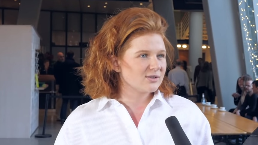 Verena Bahlsen talks to a journalist holding a microphone