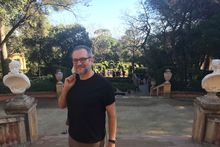 Eric Campbell poses for the photo in a garden in Barcelona.