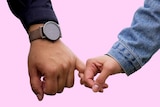 A couple gently holding hands against a pink background for a story about breaking up when the timing isn't right.