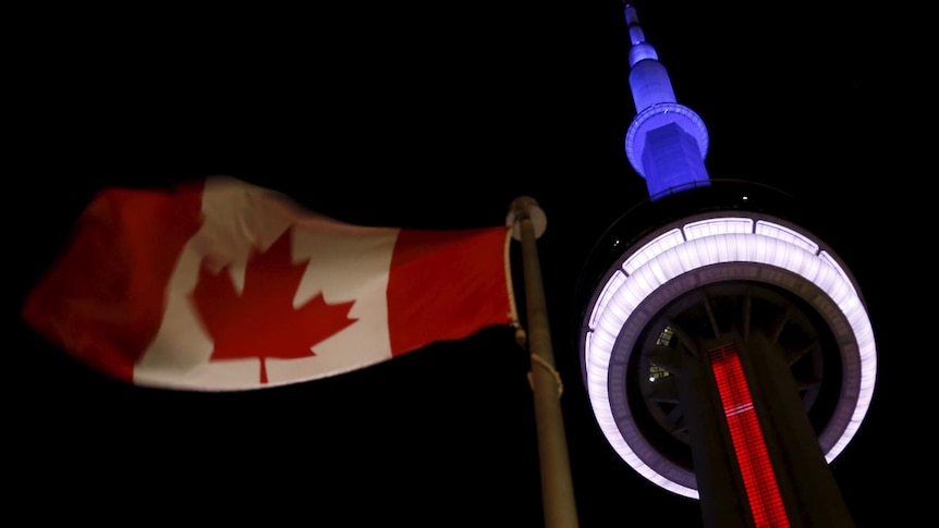 Landmark CN Tower in Toronto lit up in blue, white and red