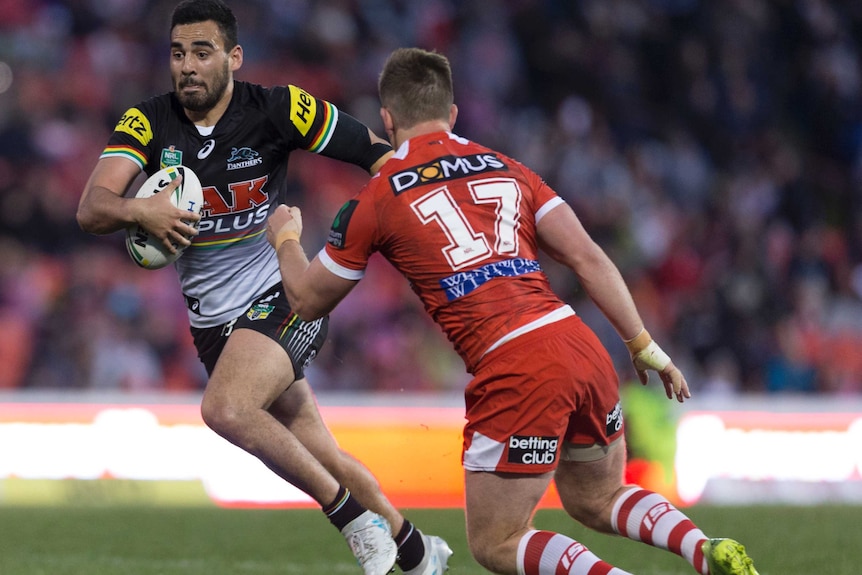 nrl player with running about to get intercepted