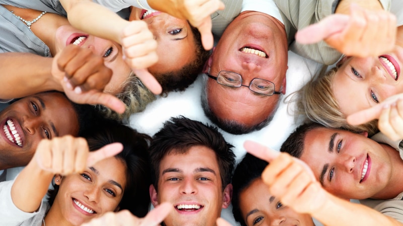 A group of people with thumbs up