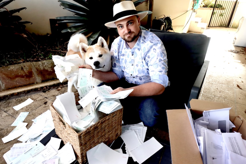 Man with dog throws envelopes around.