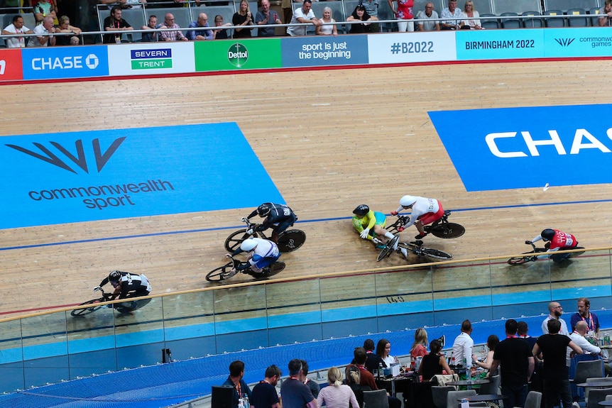 Matt Glaetzer crashes in front of another cyclist on a bend in the velodrome