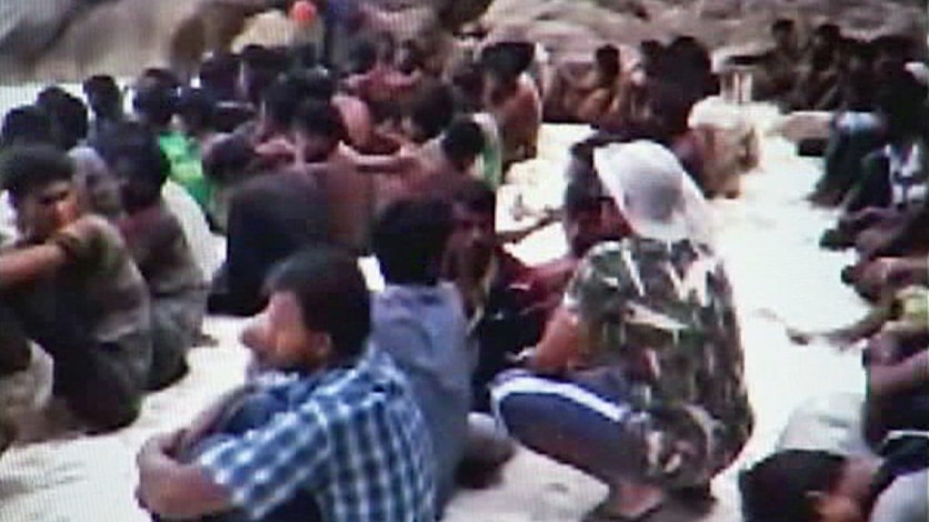 Rohingya asylum seekers sit on beach