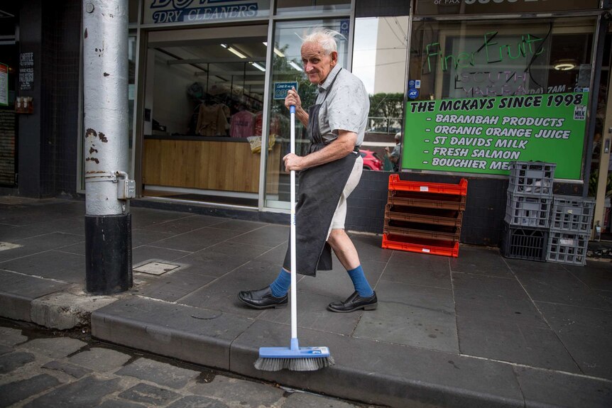 David Richardson, 77, sweeping out in front of the fruit shop where he helps out.