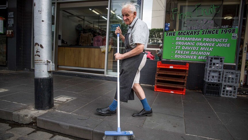 David Richardson, 77, sweeping out in front of the fruit shop where he helps out.